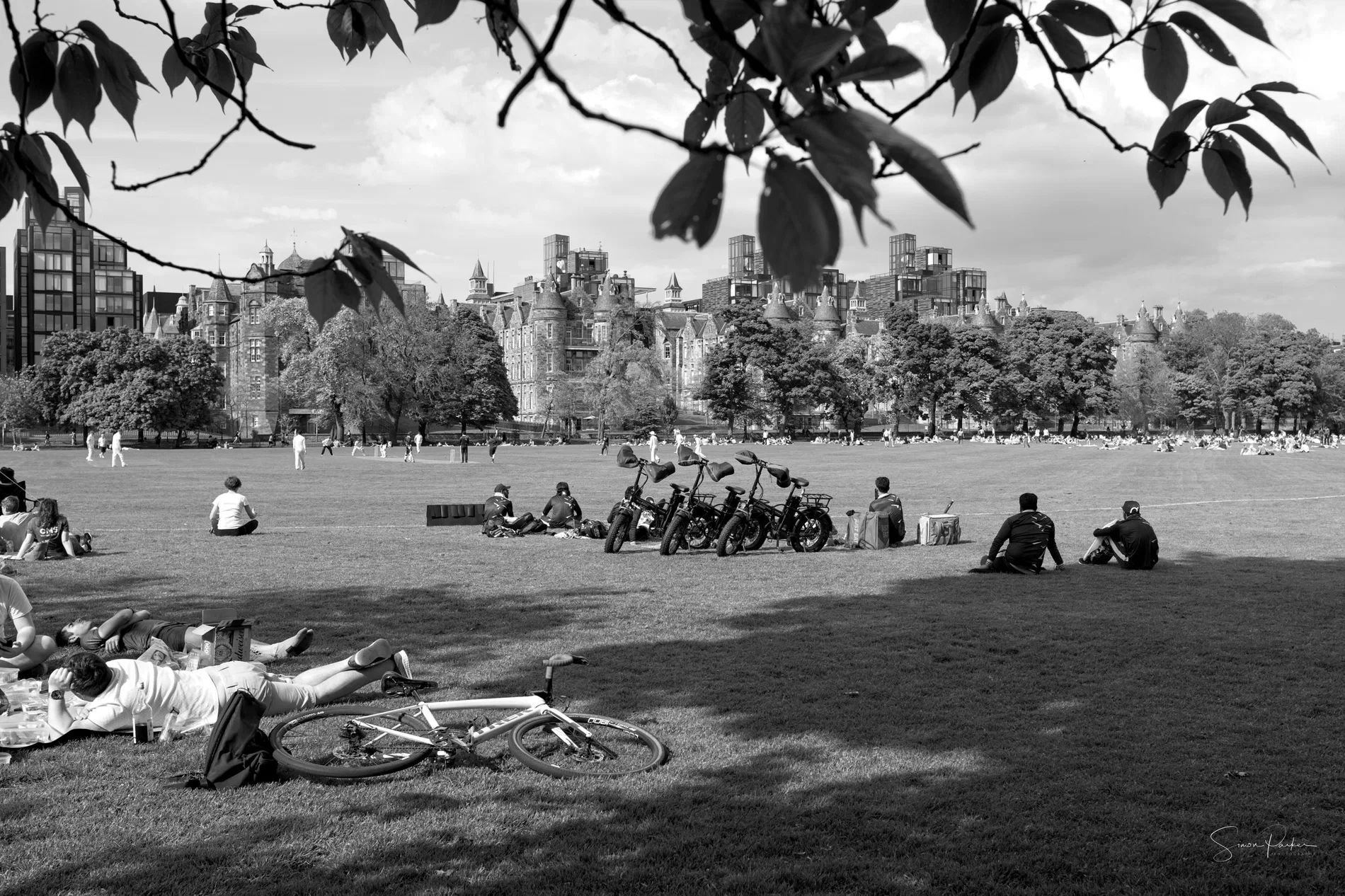 A monochrome scene in Edinburgh with people relaxing outside