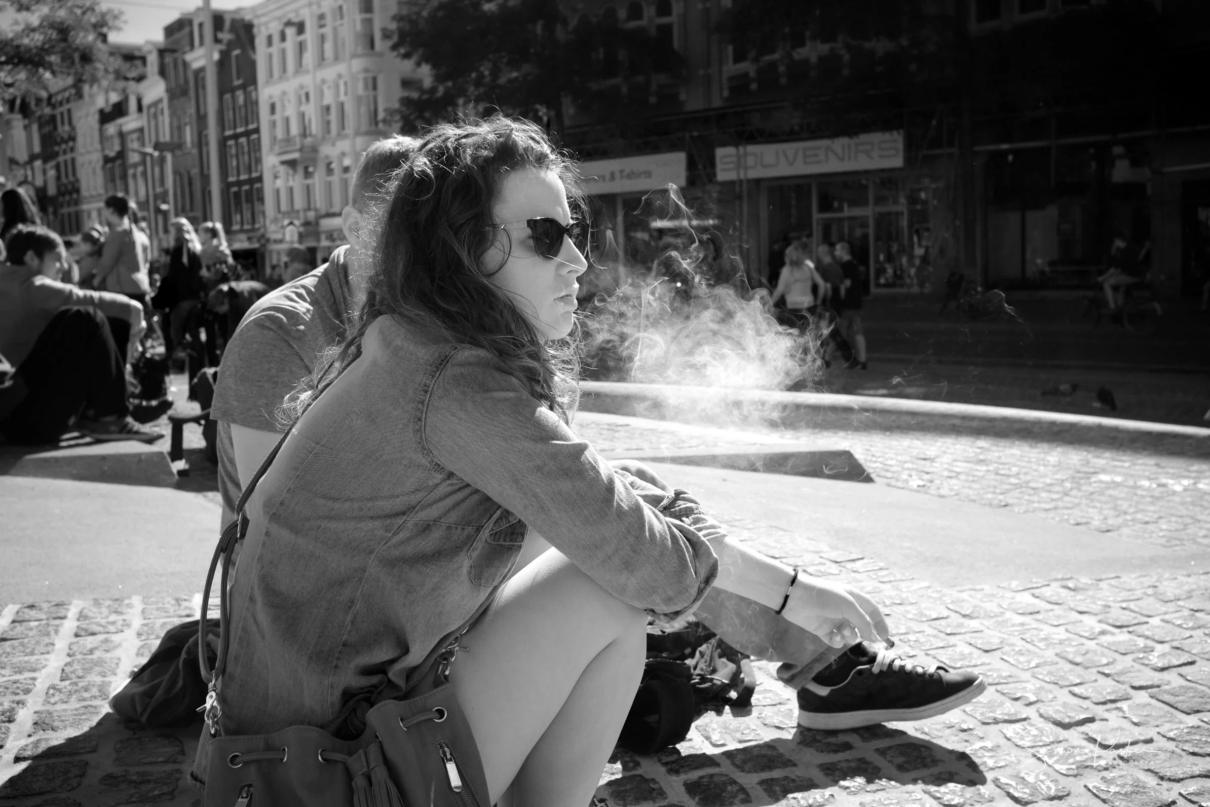 Simon's monochrome street photograph of a woman smoking in Amsterdam